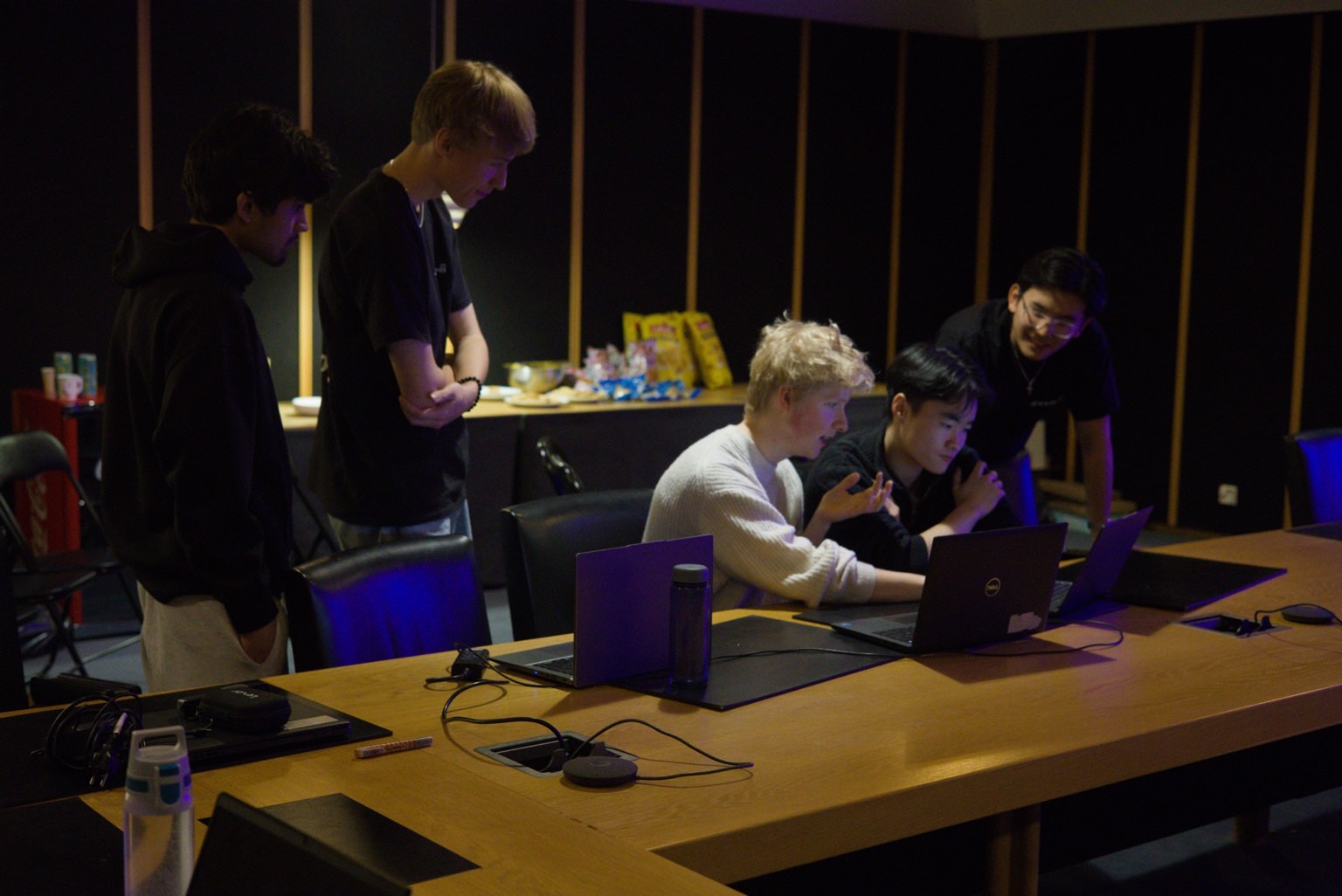 Students working together on laptops during a hackathon at Founders House